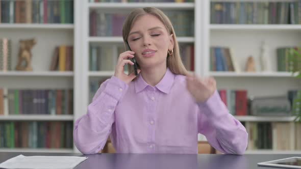 Woman Talking on Phone in Office