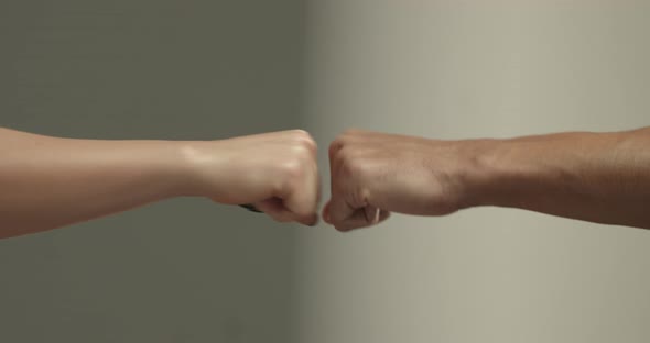 Closeup of Woman and Man Hands Do Fist Bump Gesture Two Sportsmen Greet Each Other Concept of