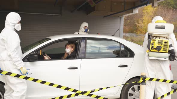 Medical Workers Measuring Temperature Woman Through Car Window Before Leaving Contaminated Zone