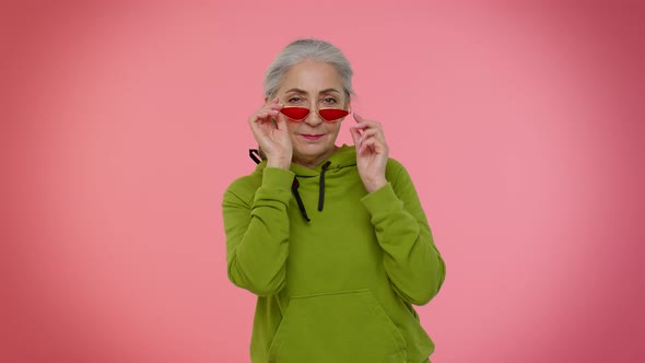 Happy Playful Elderly Stylish Granny Woman in Sunglasses Blinking Eye Looking at Camera with Smile