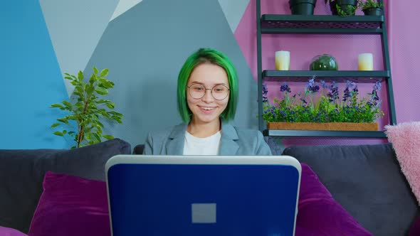 Young Woman Watching Comedy on Computer Laughing