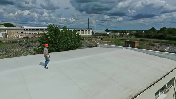 Technician in orange helmet on the roof