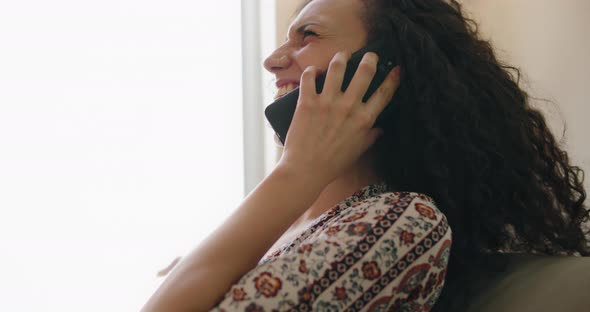 A woman with curly hair laughing