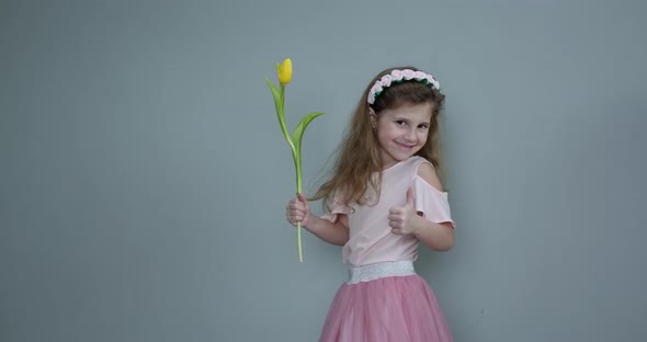 Smiling Child Girl with Spring Flower Bouquet on Background