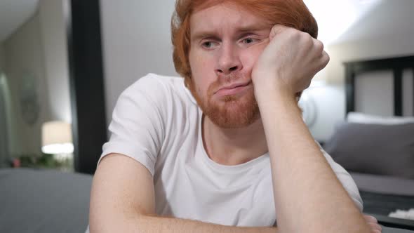 Sad Casually Sitting Redhead Man