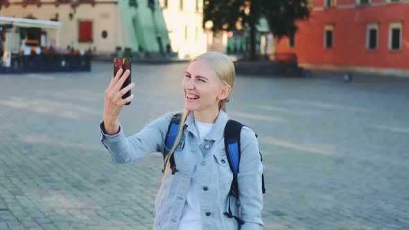 Pretty Female Tourist Making Video Call on Smartphone From the Place of Her Visit