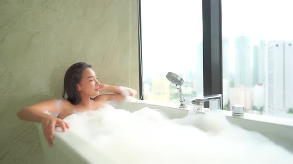 Young asian woman relax in bathtub