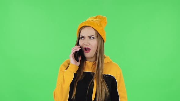 Portrait of Modern Girl in Yellow Hat Is Talking for Mobile Phone