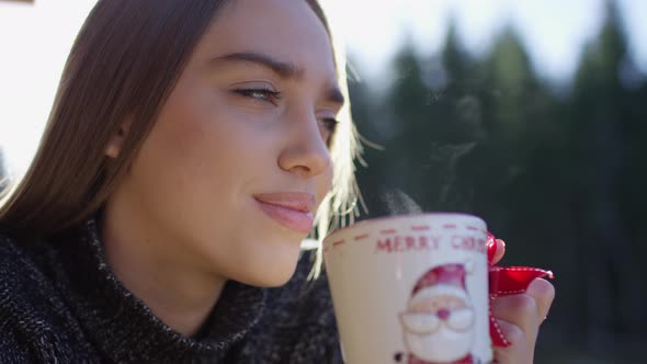 Close up of a young girl holding a mug alt