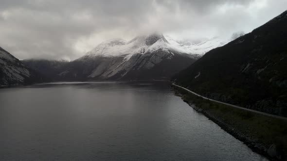 Calm Waters Of Tysfjorden With Snowy Stetind Mountain In Narvik, Nordland County, Norway. - aerial