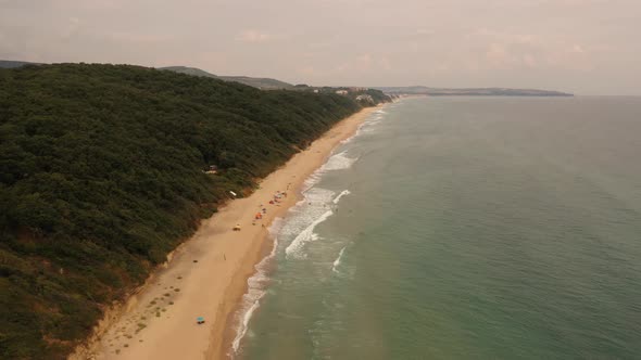 Aerial Drone Top View Over Ocean Black Sea Sand Beach Rocky Mountains Cliffs Dense Forest Bright