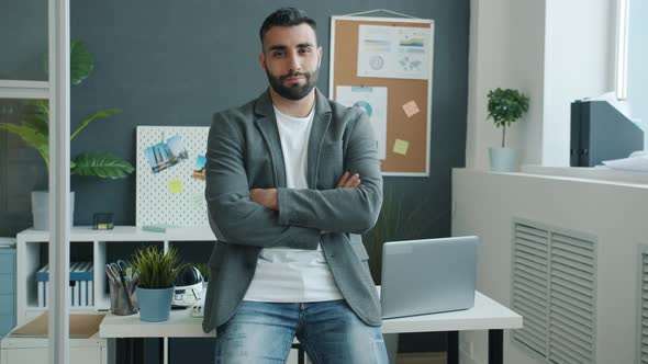 Slow Motion Portrait of Goodlooking Office Worker Standing Indoor with Arms Crossed