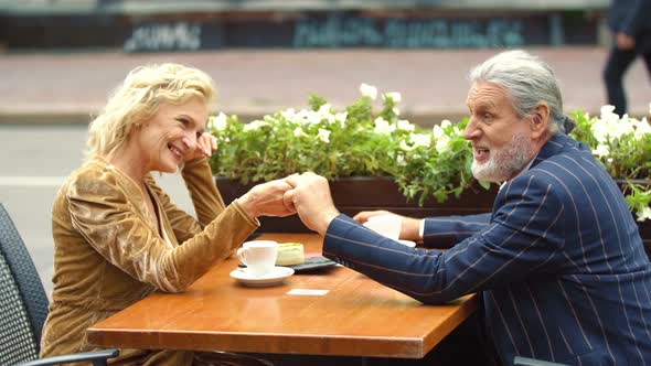 Elderly Couple Sitting at the Table