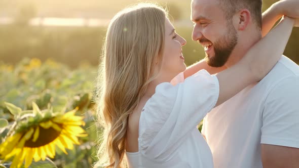 Young Man and Woman in the Sunflower Field