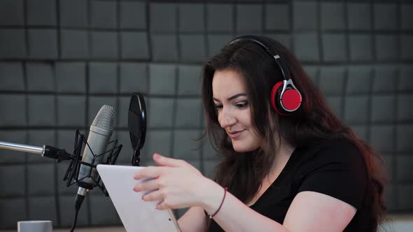 Female voice artist preparing for podcast production process on the sound recording studio