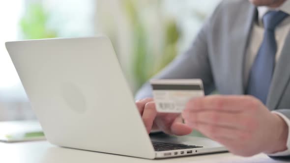 Close Up of Businessman Making Online Payment on Laptop