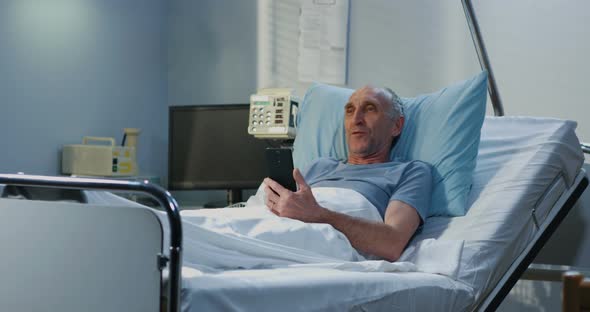 Male Patient Using Video Call in Hospital Room