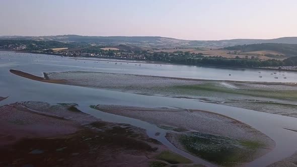 Sky view of the thriving coastal town of Lympstone England. Boats are docked close to shore, the hom