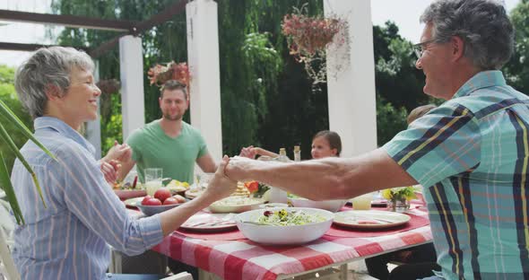 Happy family eating together at table