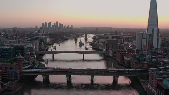 Dolly forward aerial of bridges over Thames river central London early morning sunrise