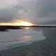 Fly over frozen winter lake towards cloudy sunset - VideoHive Item for Sale
