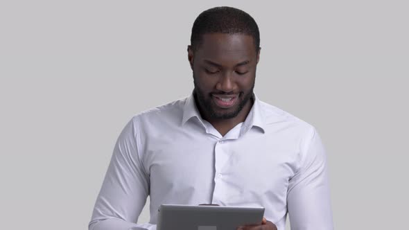 Cheerful Afro-american Businessman Using Electronic Tablet