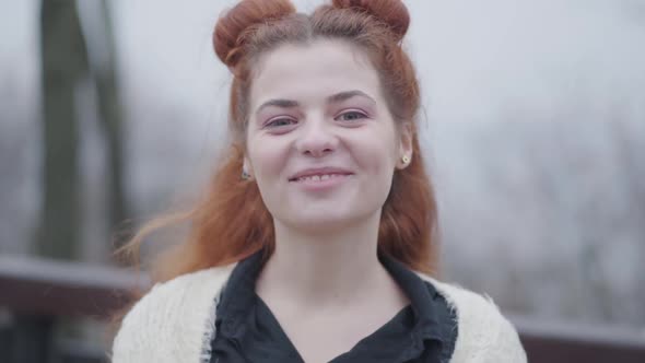 Close-up Face of Beautiful Redhead Woman Looking at Camera and Smiling