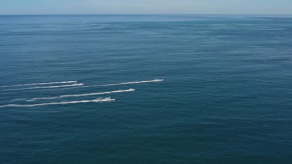 a Group of People on Jet Skis Ride on the Sea