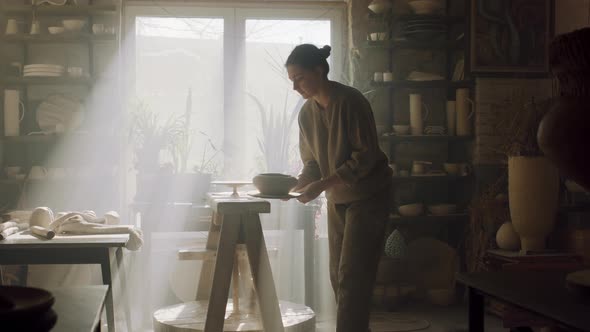 Woman Is Putting Raw Clay Pot On Rack