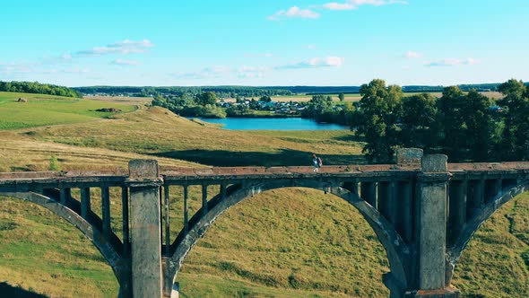 Old Bridge and an Athletic Lady Walking Along It