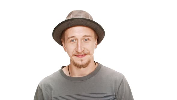 Young Handsome Man in Hat Smiling Over White Background