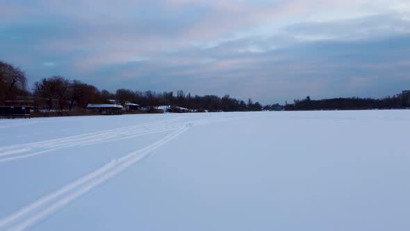 Cross-country wild ski track lines on snowy river