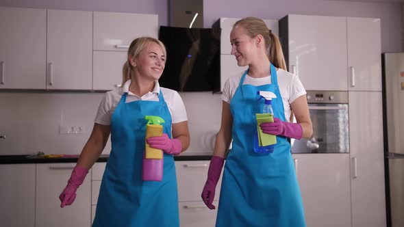 Joyful Workmates High Five After House Cleaning