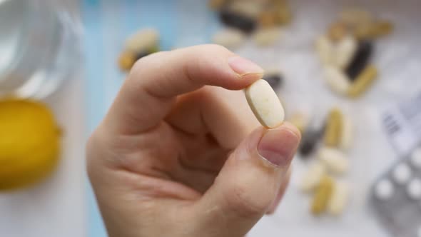 Closeup of Fingers Holding a Pill