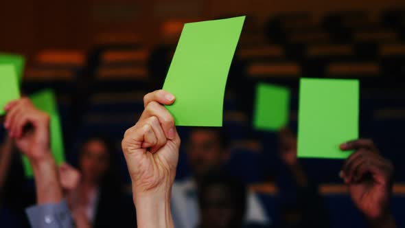 Business executives show their approval by raising hands