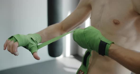 Kickboxer Bands His Hands in the MMA Club Preparations for Training in Boxing Club  120p Prores HQ