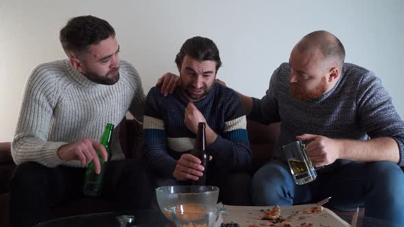 Three Male Friends Sitting on Sofa at Home