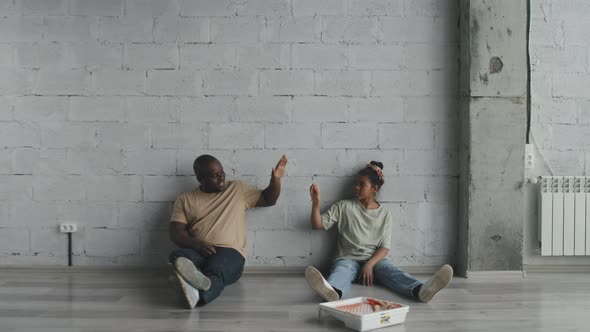 African-American Father and Girl High-Fiving