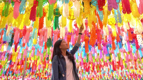 A portrait of Asian woman with colorful lanterns or lamps during travel trip and holidays vacation