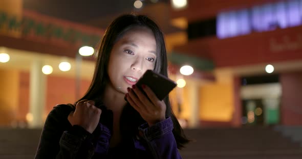 Woman sending audio message on cellphone