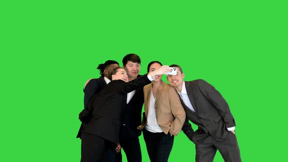 Young Happy Colleagues Making Selfies on a Green Screen Chroma Key