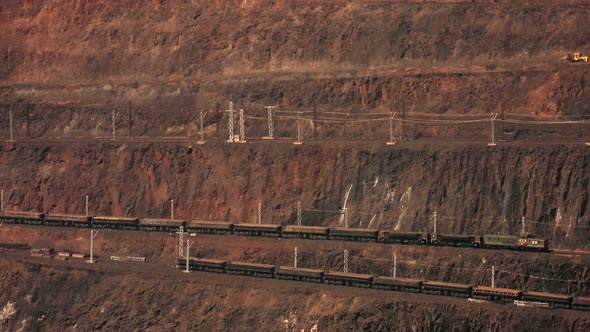 Two diesel locomotives transport iron ore from the quarry.