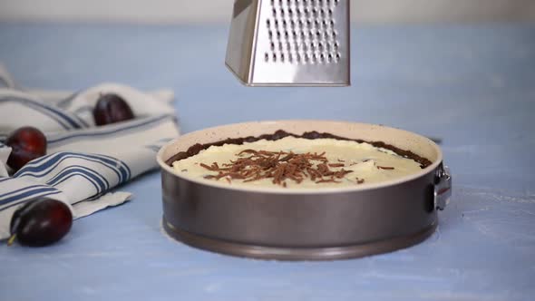 Woman's Hands Grating Pastry Dough with a Grater on the Cheesecake