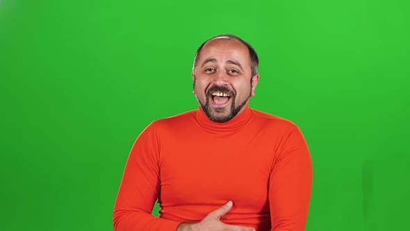 Full Caucasian Man Looking at Camera and Laughs. Green Screen. Slow Motion