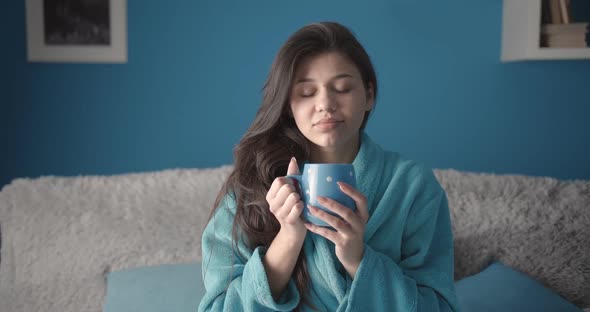 Woman Drinking Hot Coffee in Bed