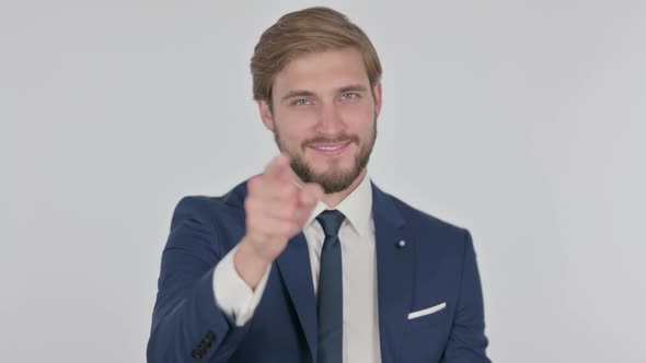 Young Businessman Pointing at Camera Inviting on White Background