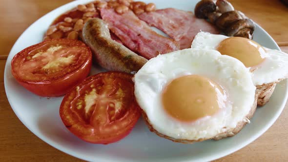 Top View of a Traditional English Breakfast in a Plate on a Wooden Table