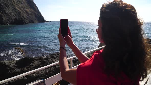 Young Beautiful Caucasian Woman in a Red Suit Going on the Beach for Practicing Yoga Fitness and