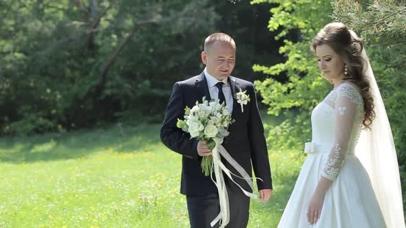 Bride and Groom at Wedding Day Walking Outdoors on Spring Nature