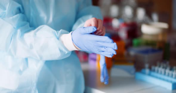 Scientist Wearing Protective Gloves - Health Care Clinic.